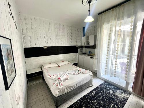 a small bedroom with a bed and a window at Delphin Hotel Side in Side