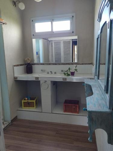 a bathroom with a sink and a mirror at Talita Cumi in Villa Santa Cruz del Lago