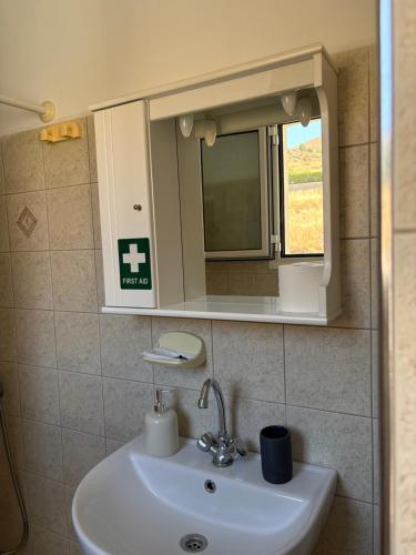 a bathroom with a sink and a medicine cabinet at Vista del Mare Rooms 1 in Agios Ioannis Kaspaka