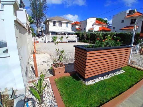 a garden with a large wooden planter in a yard at Annabelle's in Saint James