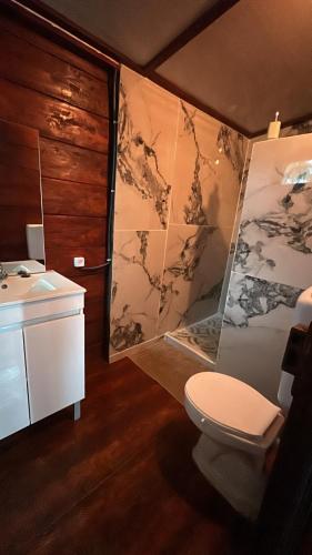 a bathroom with a toilet and a sink at Conjá Ecolodge in Porto Alegre