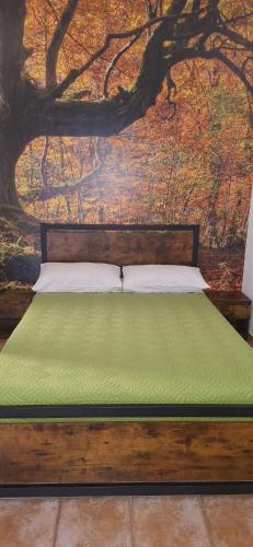 a bedroom with a bed with a painting on the wall at SIM residence in Maniago