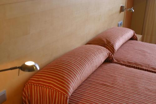 a close up of a striped couch in a room at Apartamentos Esperanza del Mar in Portonovo