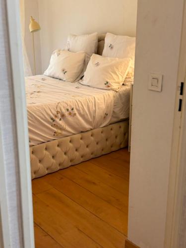 a bed with white sheets and pillows in a room at V hotel in Savigny-le-Temple
