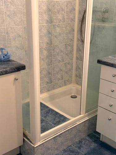 a bathroom with a shower with a tub at V hotel in Savigny-le-Temple