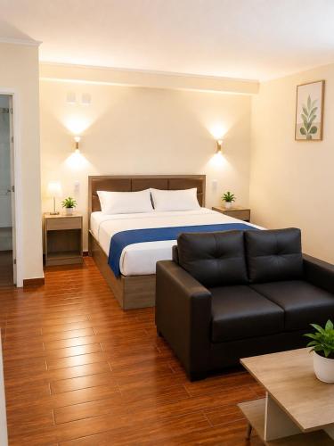 a hotel room with a bed and a couch at Hotel Asia Pacifico in Santiago
