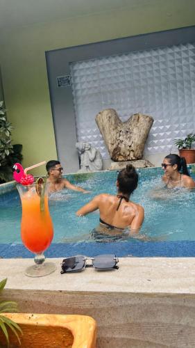 a group of people in a swimming pool at Mantra Hotel Boutique in Santa Marta