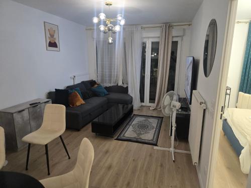 a living room with a couch and a chair at Havre de paix confort,élégance in Chelles