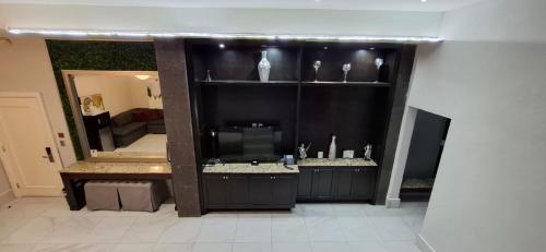 a living room with a mirror and a television at Gran Hotel Cantera La plaza in Nuevo Laredo