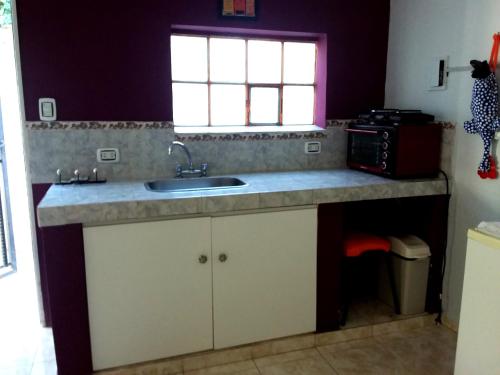 a kitchen with a sink and a window at centro 1 in General Roca