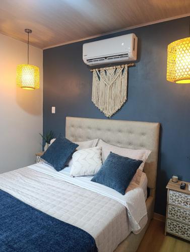 a bedroom with a bed with a air conditioner on the wall at Alma Libre 01 in Fortuna