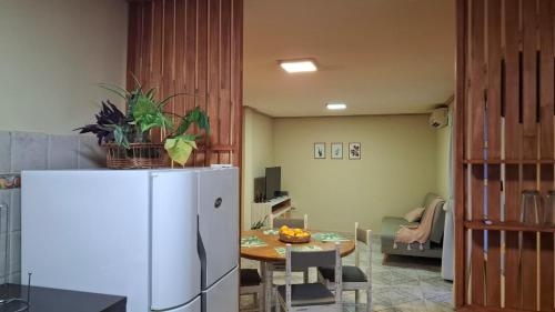 a kitchen with a table and a white refrigerator at Depto Libertad 1 in San Francisco