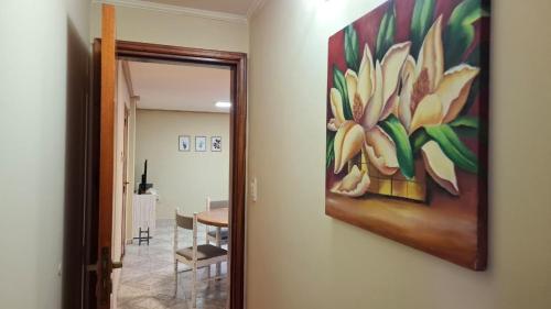 a painting of a flower hanging on a wall at Depto Libertad 1 in San Francisco