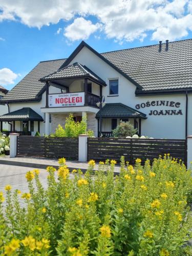a building with a sign for a hotel at Gościniec Joanna in Rajgród