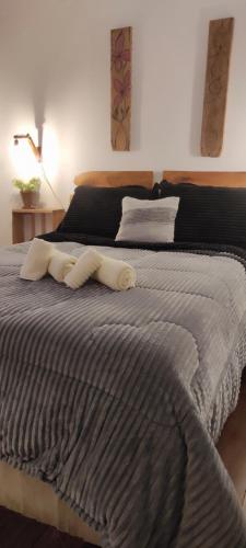 a large bed with two towels on top of it at Pueblo Nómade in Tranqueras
