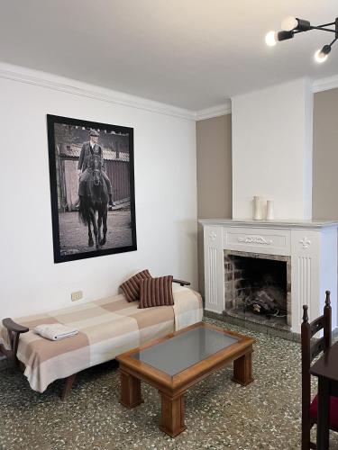a living room with a couch and a fireplace at Lomar Apart 2 - Depto céntrico Villa María in Villa María