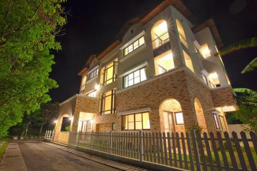 a large building with a fence in front of it at Mallorca B&B in Taitung City