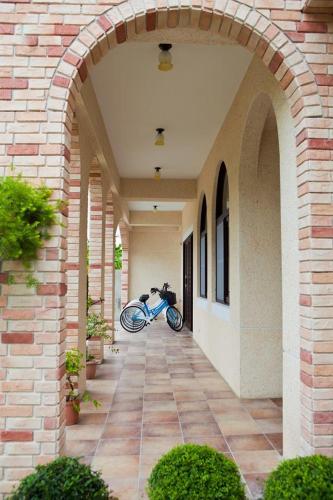 a motorcycle parked under an archway in a building at Mallorca B&B in Taitung City