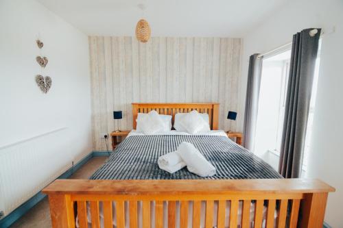 a bedroom with a bed with two pillows on it at The Graigfryn Hideaway in Amlwch