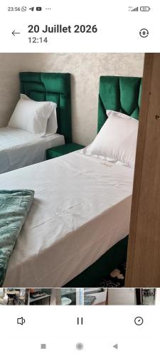 two beds sitting next to each other in a room at Résidence Hala in Tan-Tan