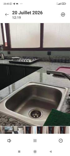 a picture of a kitchen sink with a green sponge at Résidence Hala in Tan-Tan
