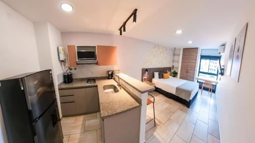 a kitchen and a bedroom with a bed in a room at Hotel Molinos by Growing Group in Medellín