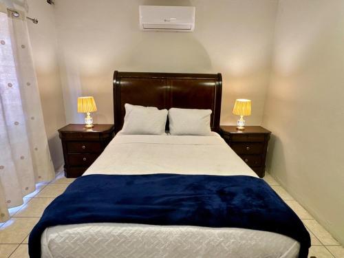 a bedroom with a large bed with two night stands at Luxurious Platinum House 3VX in San Pedro Sula