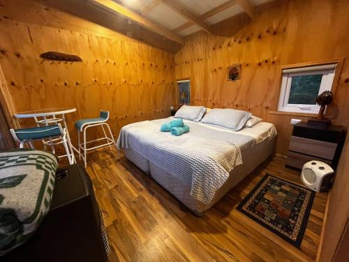 a bedroom with a bed in a wooden room at Domos y Cabañas Antu Mahuida in Melipeuco