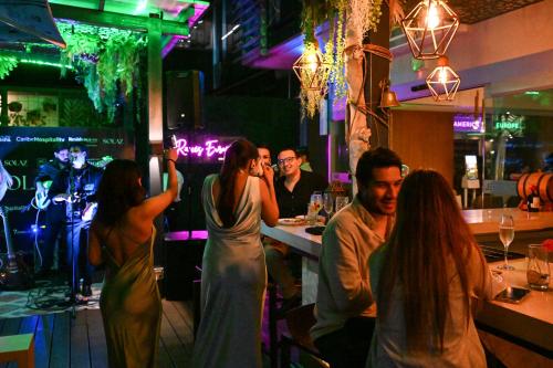 a group of people sitting at a bar at AC Hotel by Marriott San Jose Escazu in San José