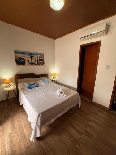 a bedroom with a large bed in a room at Studio Praia do Chapéu in Mata de Sao Joao