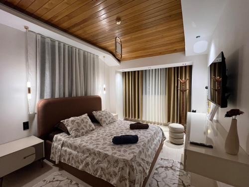 a bedroom with a bed and a television in a room at Suite cobalt suite nova suite évasion in Mostaganem