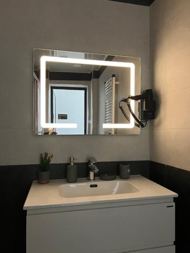 a bathroom with a sink and a mirror at Suite cobalt suite nova suite évasion in Mostaganem