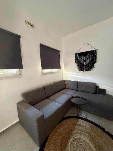 a living room with a couch and a table at Coconut beach villas 4 in Schinias