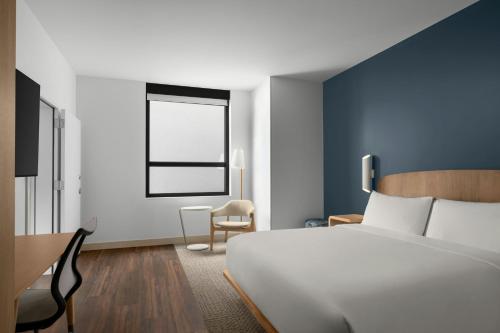 a bedroom with a white bed and a window at Element by Marriott Boise Downtown in Boise