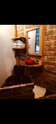 a bathroom with a sink and a mirror at Cabaña en la Calera con Sauna in La Calera