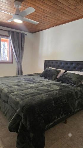 a large bed in a bedroom with a ceiling at Aromas de Cafayate in Cafayate