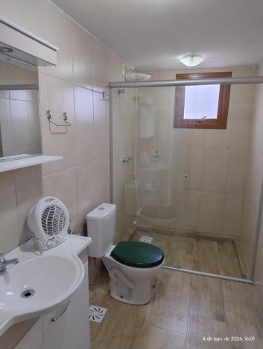a bathroom with a shower and a toilet and a sink at Pousada Relicário in Nova Petrópolis