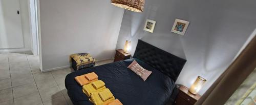 a bedroom with a blue bed with yellow pillows at Nuestra Recova 2 en Pilar BsAs in Pilar