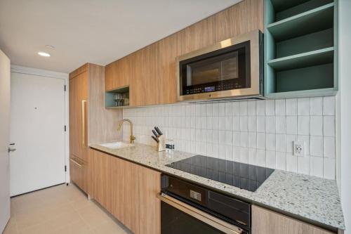 a kitchen with a sink and a microwave at NEW Luxury Bay View Downtown 1 Bedroom in Miami