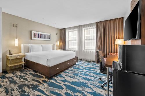 a hotel room with a bed and a television at Hotel Felix in Chicago