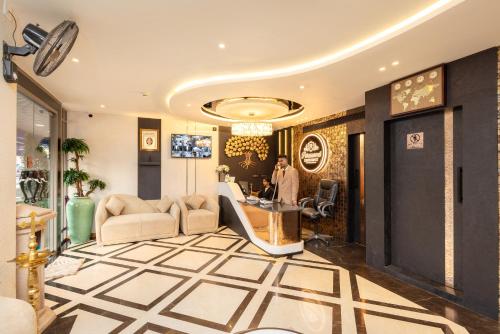 a man standing in a lobby with a hair salon at Paramount Residency in Nedumbassery