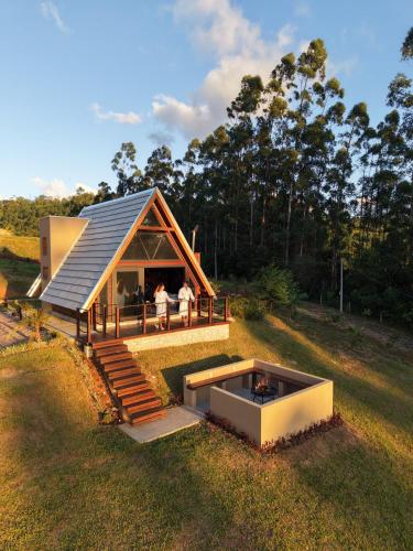 a house with a pool in the middle of a field at Caramelo Chalé in Rio do Sul