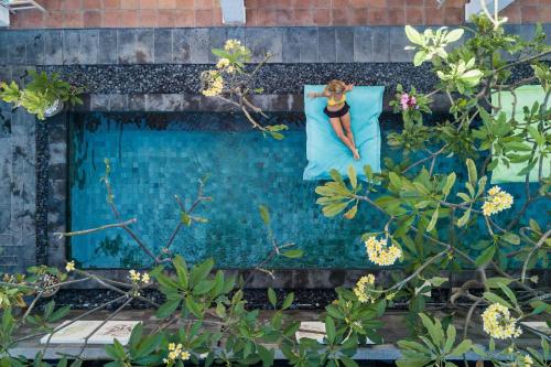 a painting of a woman in a dress on a window at Blue Marlin Dive Resort Trawangan in Gili Trawangan