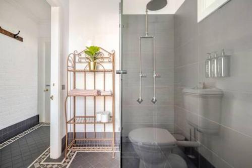 a bathroom with a toilet and a shower at William Arnott Boutique Accommodation in Morpeth