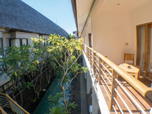 a balcony with trees and a wooden railing at Blue Marlin Dive Resort Trawangan in Gili Trawangan