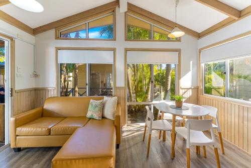 a living room with a couch and a table at Ingenia Holidays Soldiers Point in Soldiers Point
