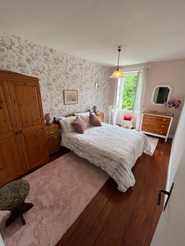 a bedroom with a large bed and a window at Sundown in Paillé