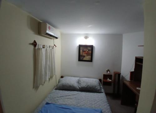 a small room with two beds and a window at Neyen in La Plata