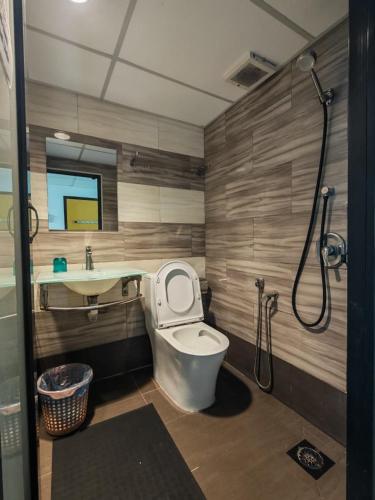 a bathroom with a toilet and a sink and a shower at Comfort Two Hotel in Malacca