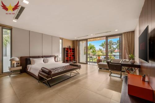 a bedroom with a bed and a desk and a couch at The Five Stars Villa 6 Bedrooms Beachfront in Danang